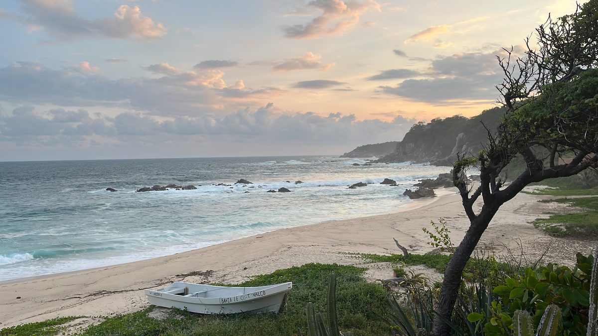 The wild coastline of Playa Salchi at sunset