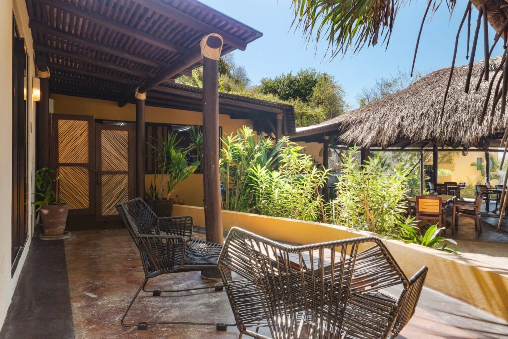 Shaded terrace with lounge chairs and garden