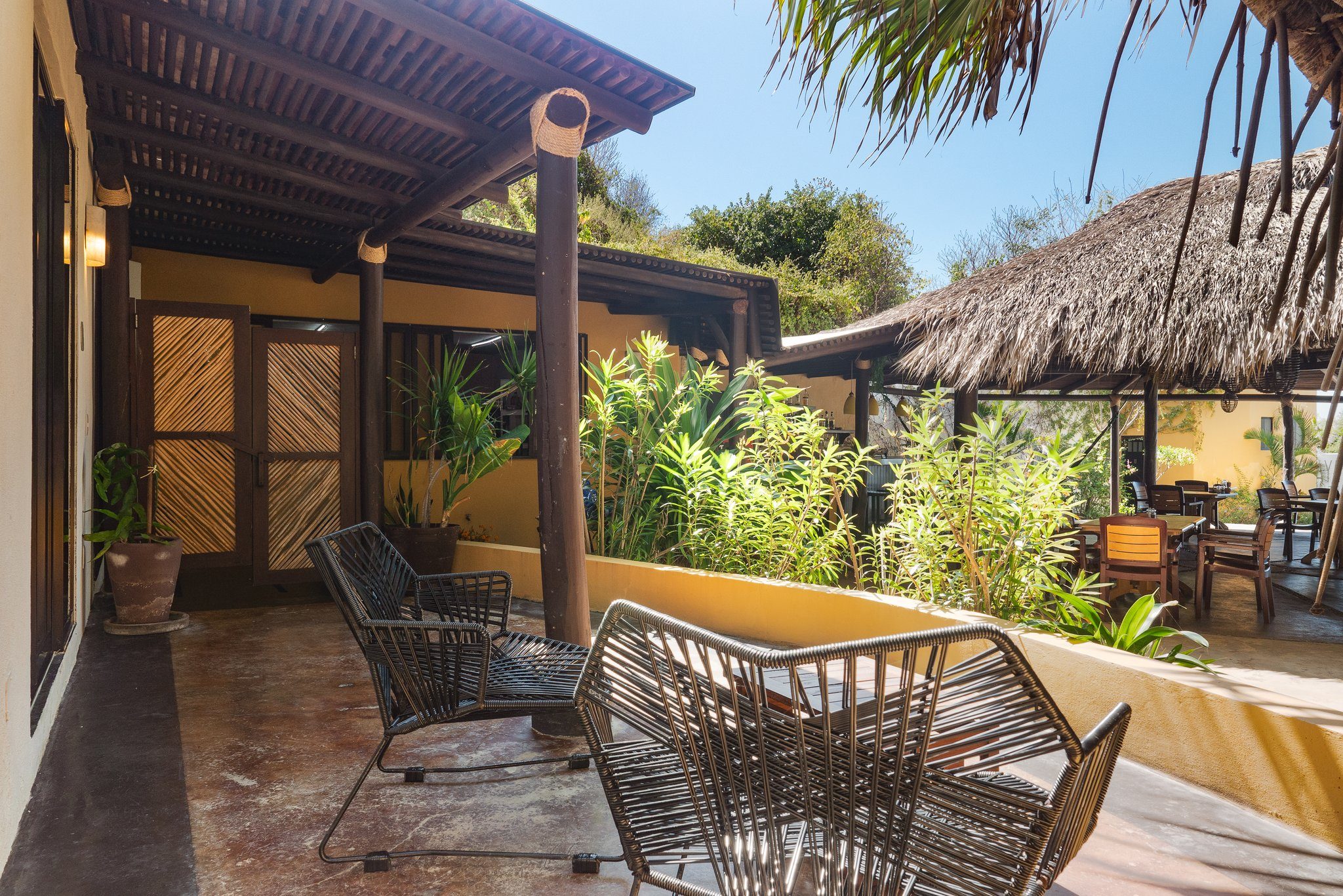 Shaded terrace with lounge chairs and garden