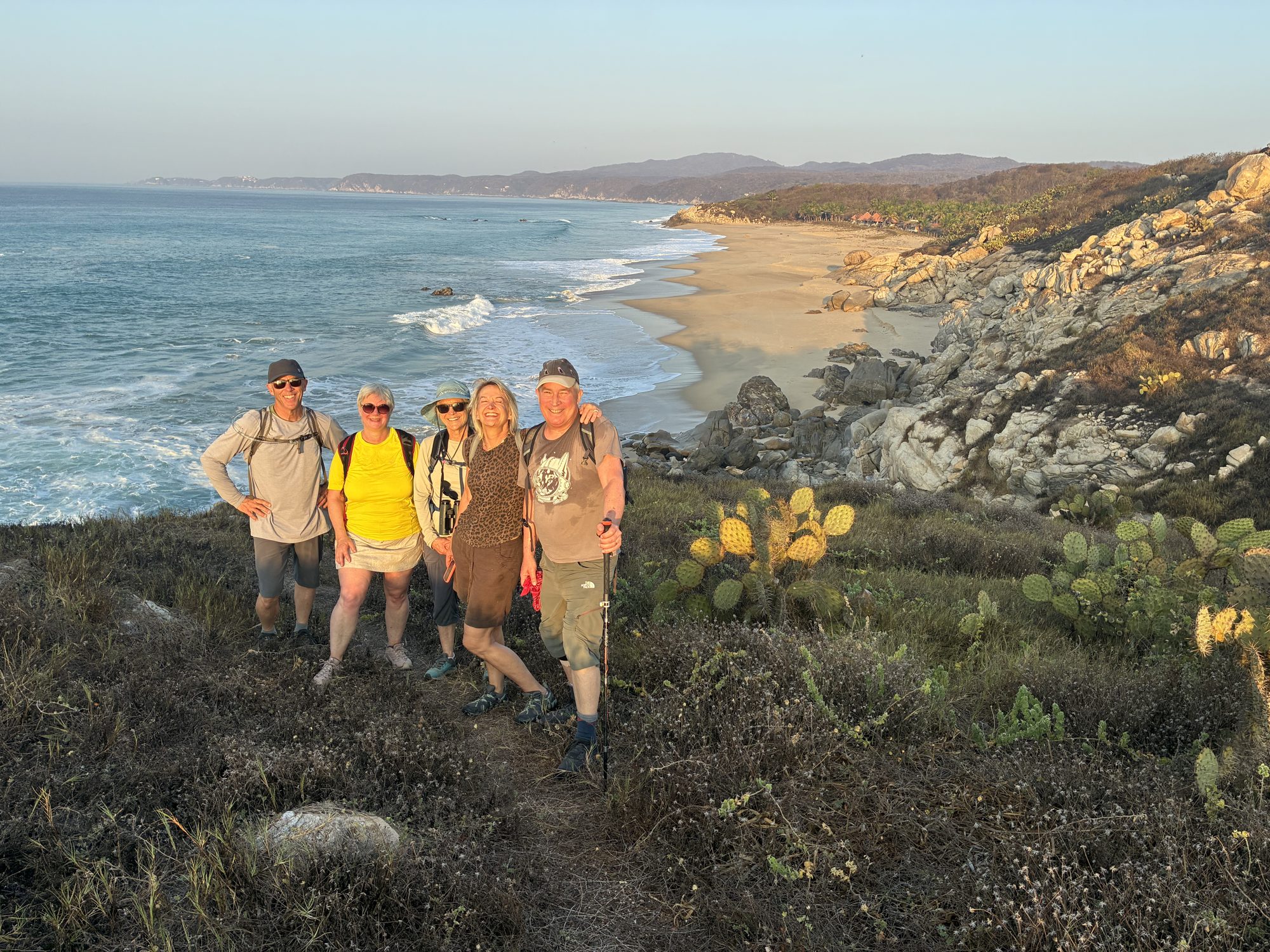 Hikers on a clifftop trail above the beaches near Salchi