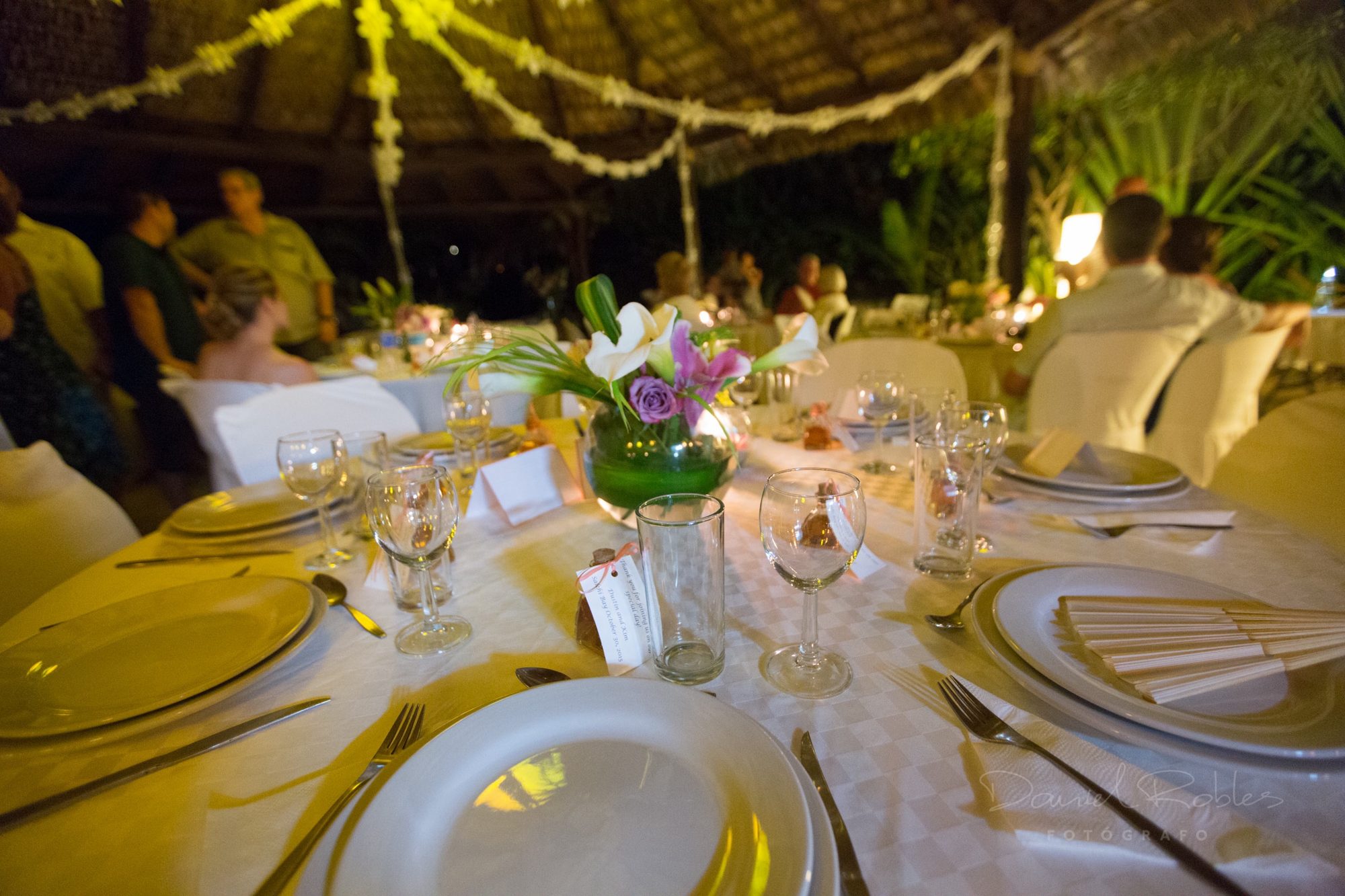 Place settings with crystal glasses and orchids